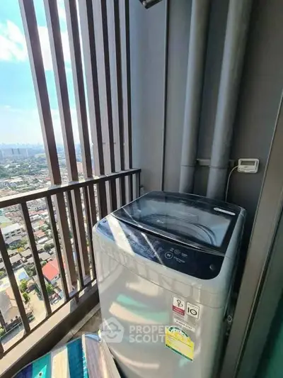 Modern high-rise balcony with washing machine and city view