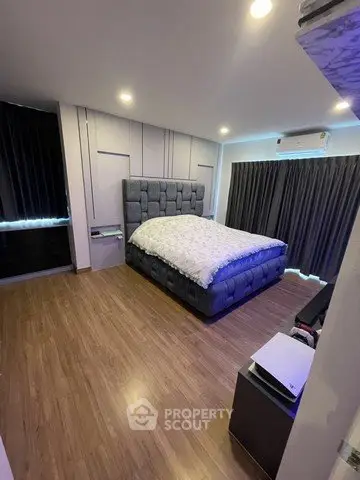 Spacious bedroom with modern decor and cozy lighting