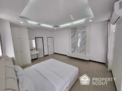 Luxurious modern bedroom with elegant marble accent wall and ambient lighting