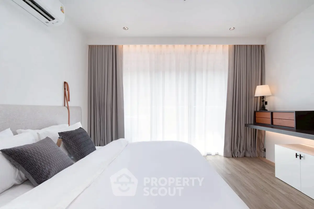 Elegant bedroom with modern decor and natural light