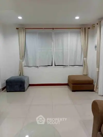 Spacious living room with large windows and modern seating