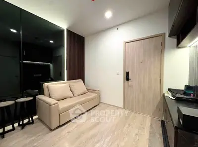 Modern living room with sleek design and neutral tones, featuring a comfortable sofa and stylish decor.