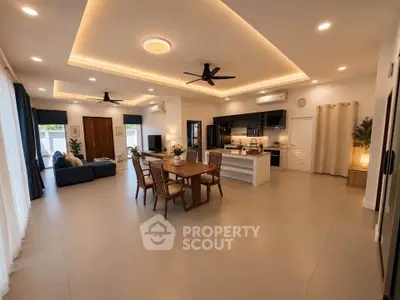 Spacious modern living room with open kitchen, elegant lighting, and stylish decor.