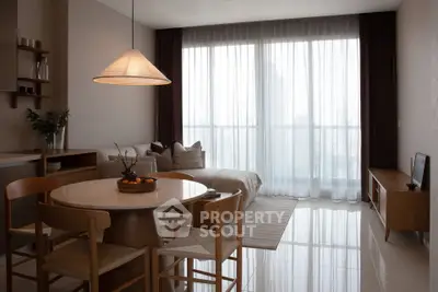 Modern open-plan living room with dining area and large window view.