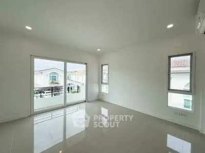 Spacious empty room with large windows and glossy floor tiles, perfect for customization.