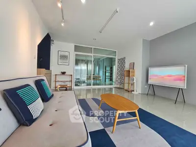 Spacious modern living room with stylish decor and large windows for natural light.