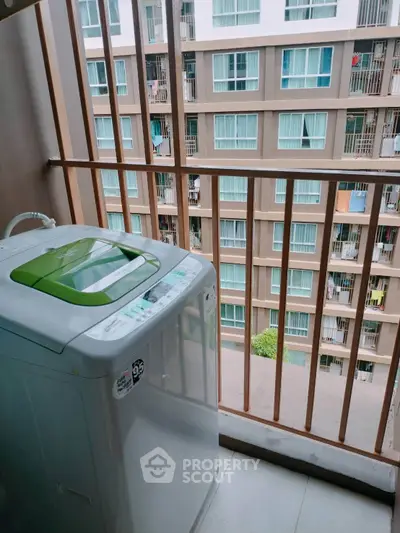 Modern apartment balcony with washing machine and city view