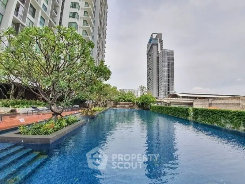 Luxurious high-rise apartment with stunning pool and lush greenery