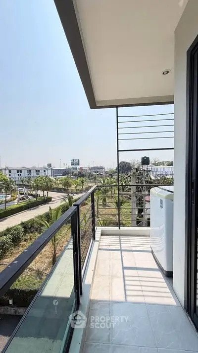 Spacious balcony with scenic view of cityscape and greenery, perfect for relaxation and outdoor enjoyment.