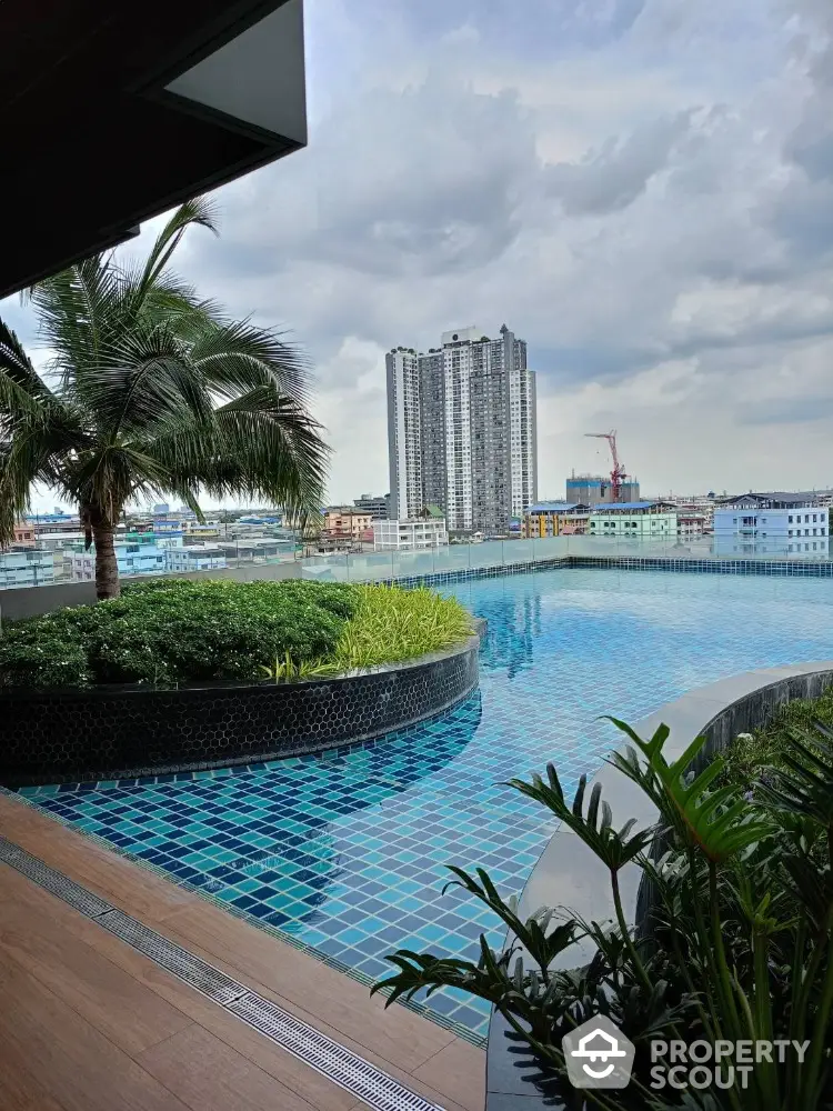 Stunning rooftop pool with cityscape view and lush greenery