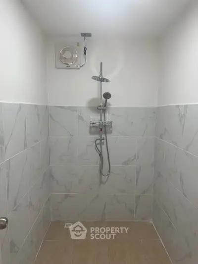Modern bathroom with sleek shower and marble tiles