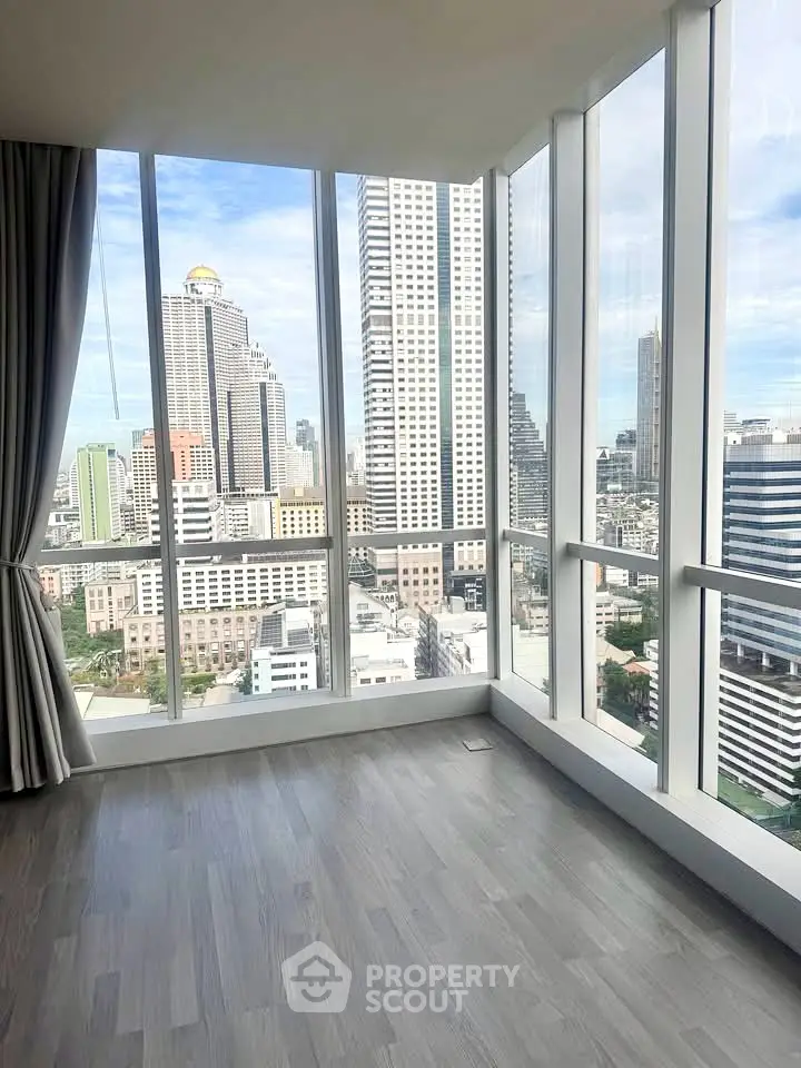 Stunning high-rise corner unit with panoramic city views and floor-to-ceiling windows.