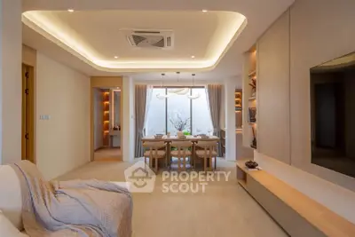Elegant modern living room with open dining area and stylish lighting