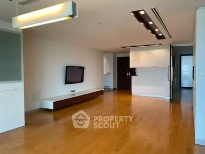 Spacious modern living room with wooden flooring and sleek lighting