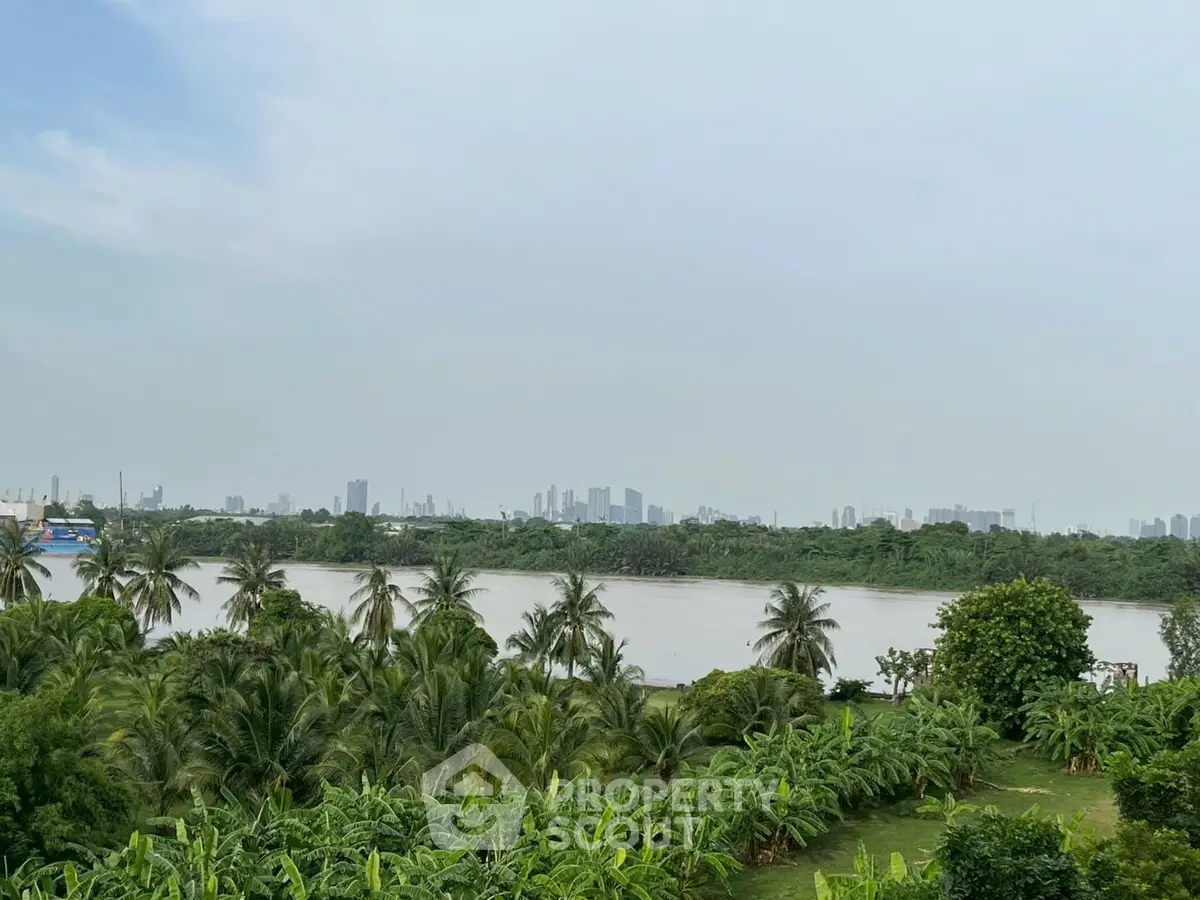 Stunning river view with lush greenery and city skyline in the background