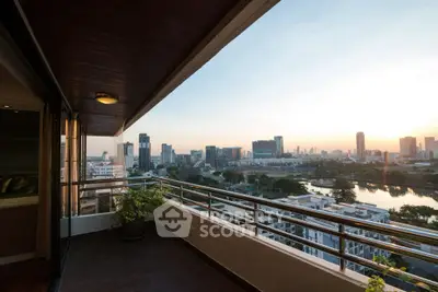 Stunning city view from a spacious balcony at sunset, perfect for relaxation.