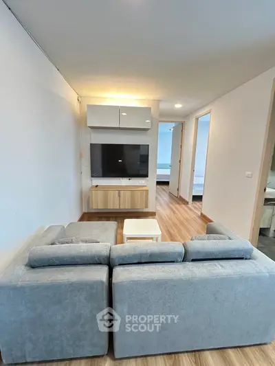 Modern living room with sleek furniture and wooden flooring