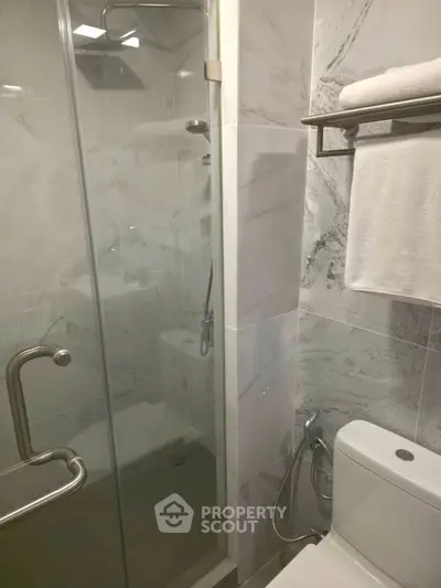 Modern bathroom with sleek shower and towel rack