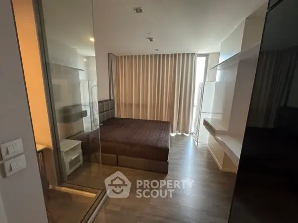Modern bedroom with glass partition and floor-to-ceiling curtains