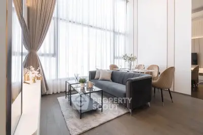 Elegant living room with high ceilings, large windows, and modern furniture in a luxury apartment.