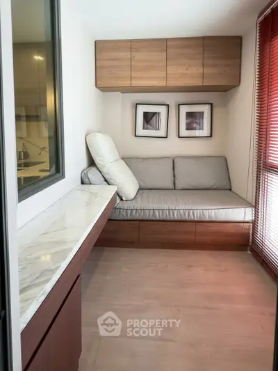 Cozy nook with built-in seating and marble countertop, perfect for relaxation or reading.