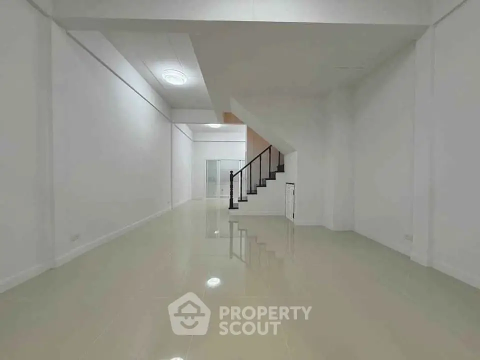 Spacious modern interior with sleek staircase and glossy tiled floors