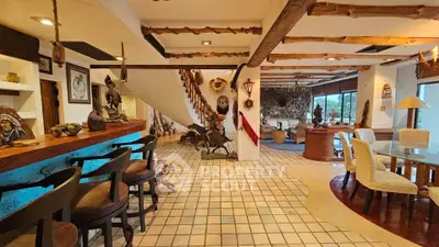Stunning rustic living room with unique decor and open layout, featuring a cozy bar area and scenic views.