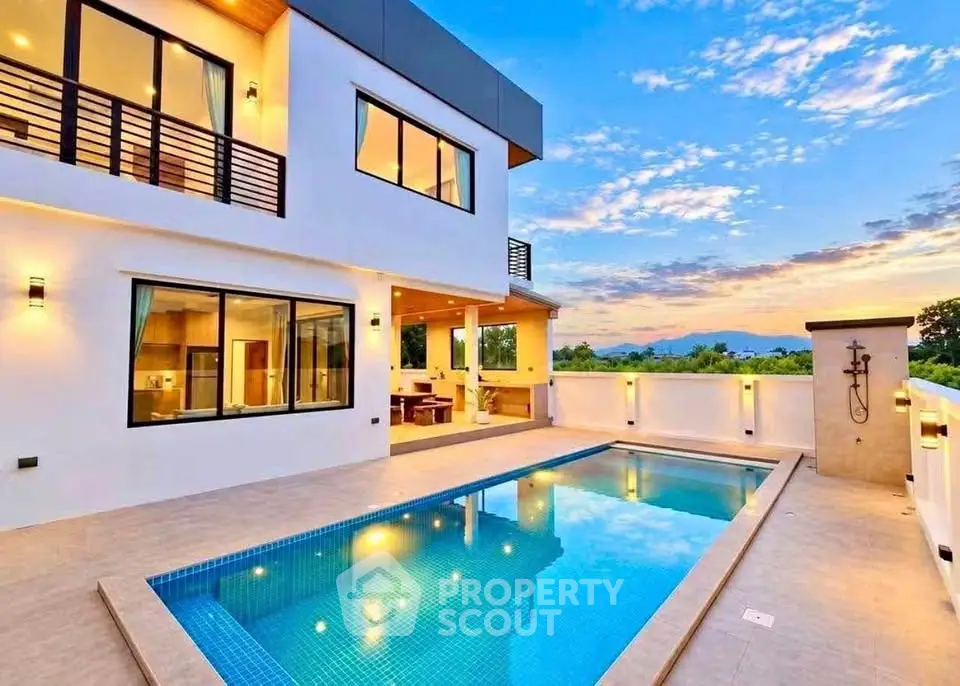 Luxurious modern home with stunning pool and scenic sunset view