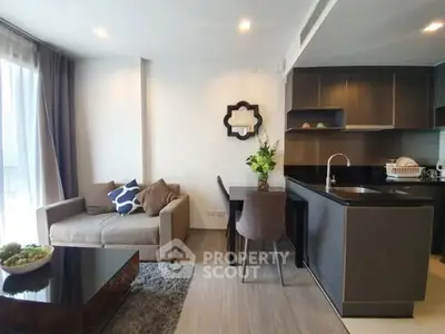 Modern open-layout living room with stylish kitchen and cozy seating area