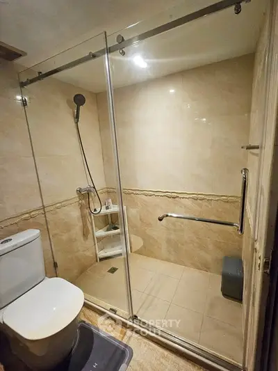 Modern bathroom with glass shower enclosure and elegant tile design