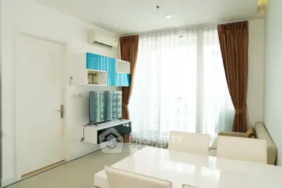 Modern living room with sleek furniture and large window for natural light