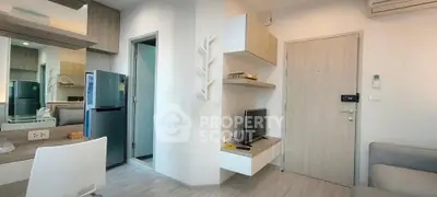 Modern apartment interior with sleek design, featuring a compact kitchen and cozy living area.