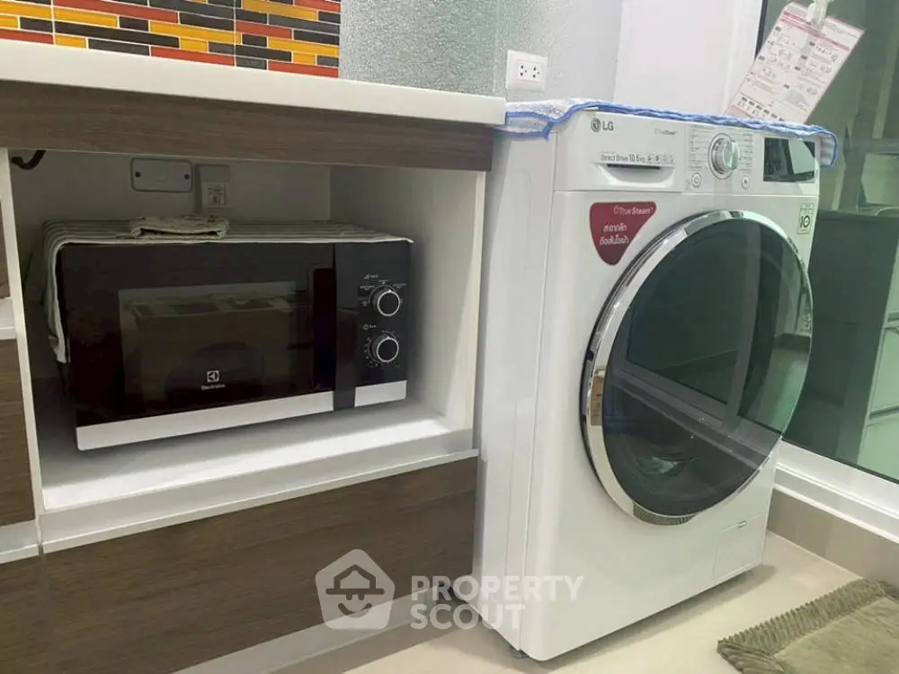 Modern kitchen with built-in microwave and washing machine