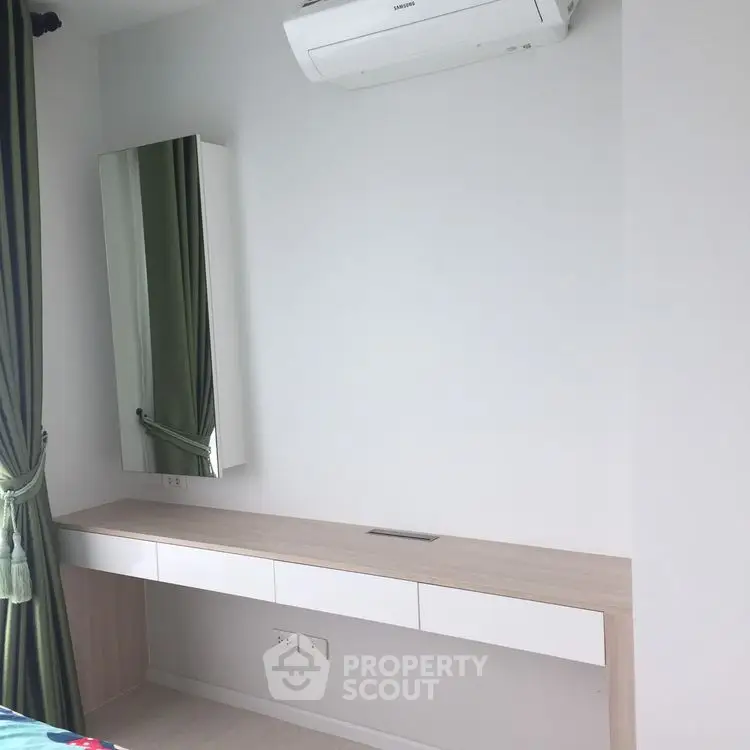 Modern minimalist bedroom with air conditioning and sleek furniture design.