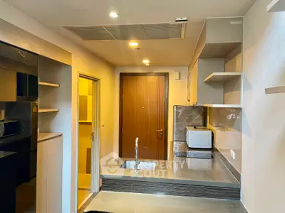 Modern kitchen with sleek countertops and built-in appliances in a stylish apartment.