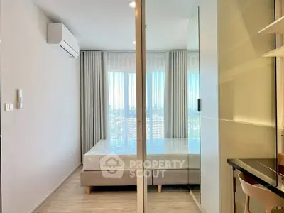 Modern bedroom with large windows and sleek design in a high-rise apartment.