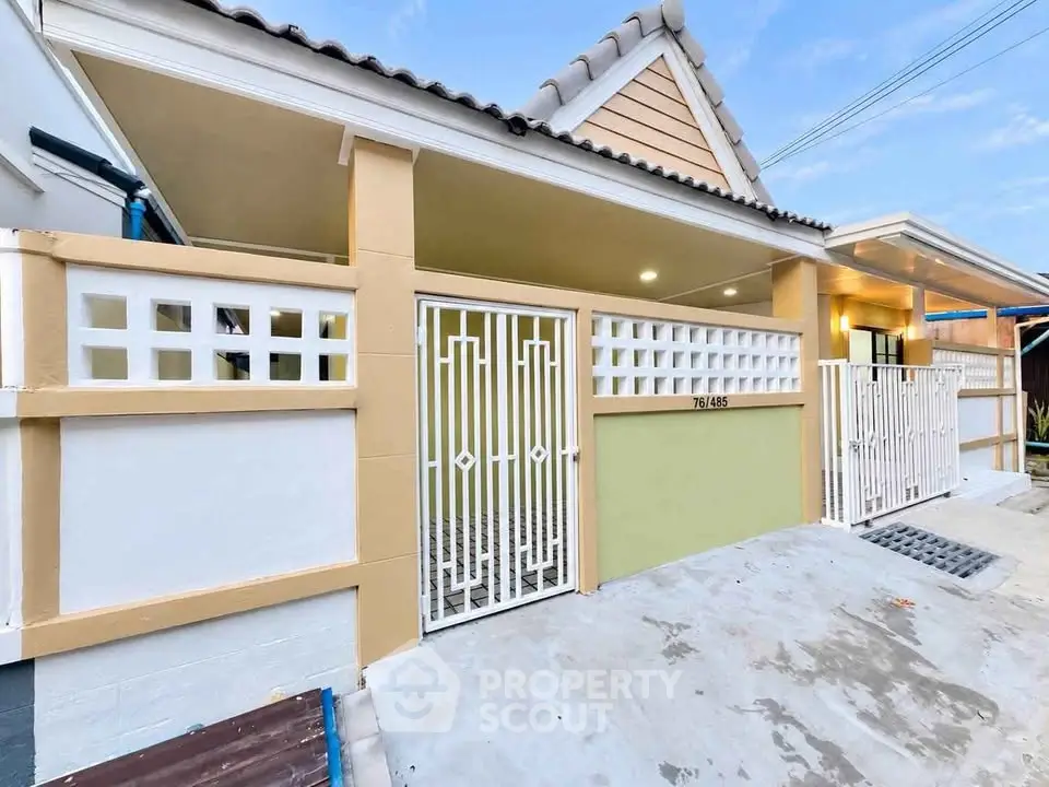 Charming single-story home with gated entrance and modern exterior design, perfect for family living.