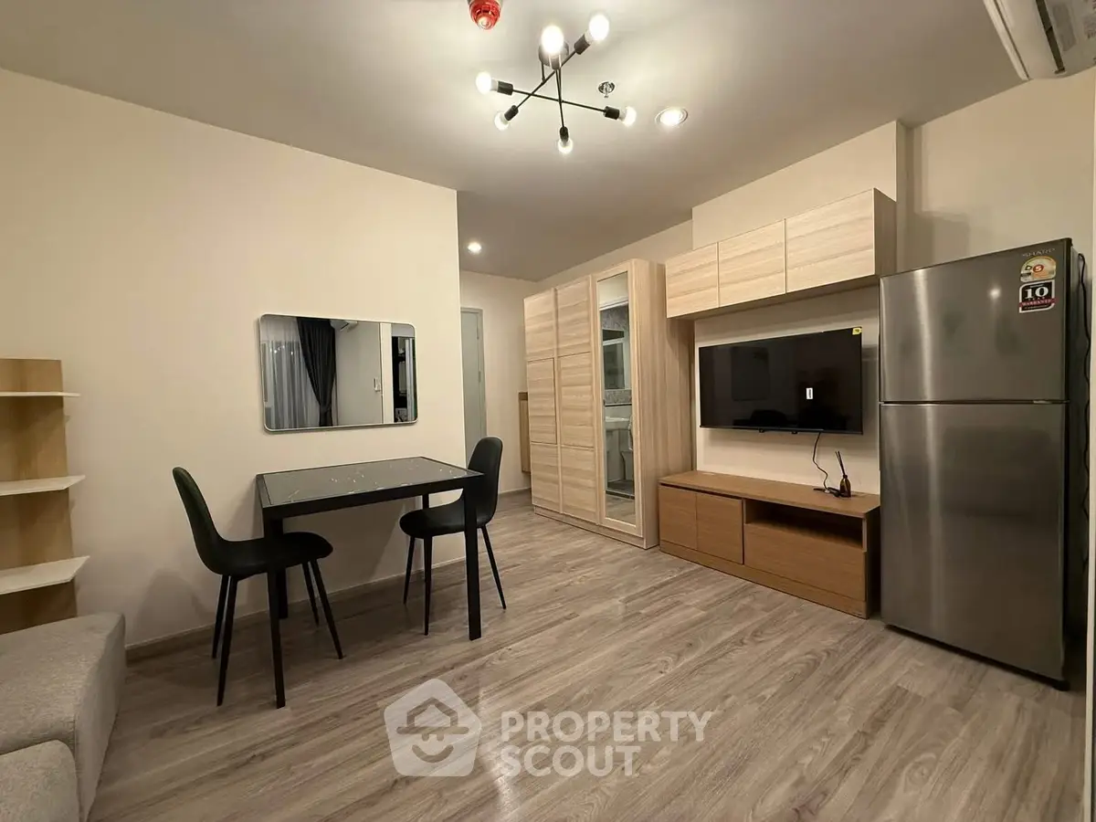 Modern apartment interior with sleek dining area and stylish storage solutions.