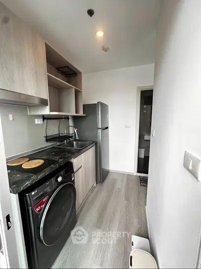 Modern compact kitchen with sleek appliances and stylish cabinetry