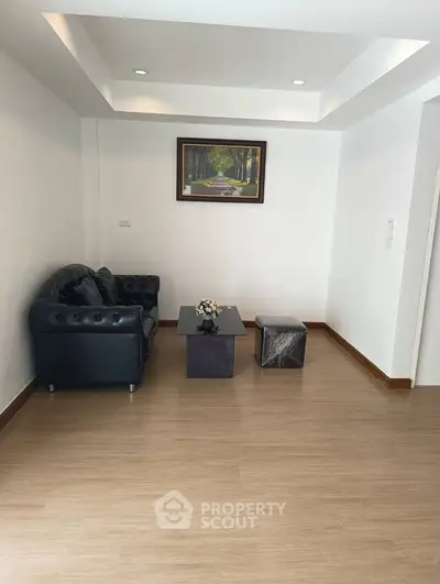 Modern living room with sleek black sofa and minimalist decor