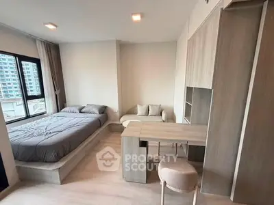 Modern bedroom with stylish furniture and large window offering city view