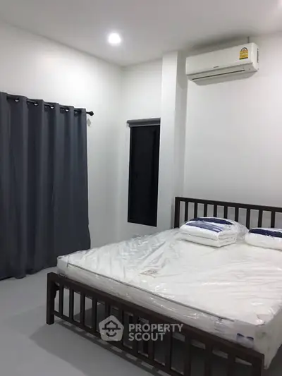 Modern bedroom with air conditioning and minimalist decor