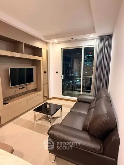 Modern living room with sleek leather sofa and city view balcony