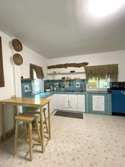 Charming kitchen with rustic decor and open layout, featuring a breakfast bar and ample natural light.