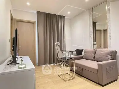 Modern living room with sleek furniture and stylish decor, featuring a cozy sofa and a flat-screen TV.