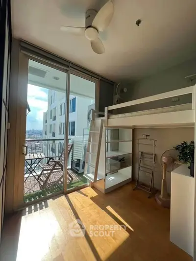 Bright studio apartment with loft bed and balcony offering stunning city views.