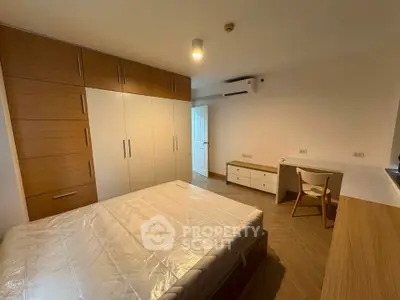 Modern bedroom with wooden accents and built-in wardrobe