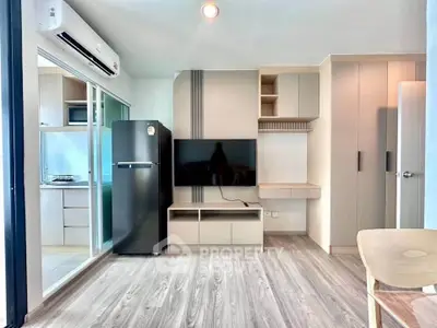 Modern living room with sleek design, featuring a flat-screen TV, air conditioning, and stylish storage solutions.