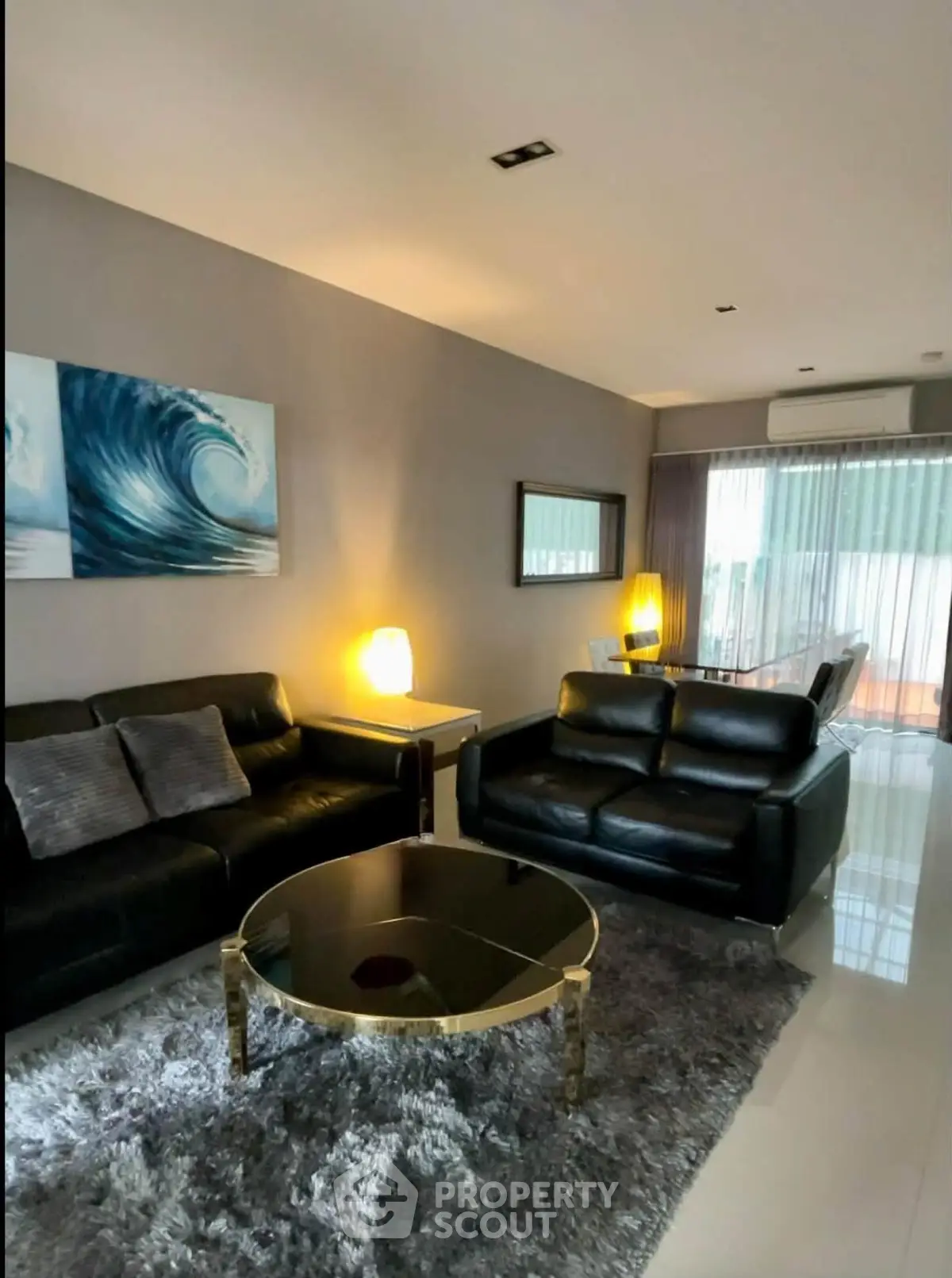 Modern living room with sleek black leather sofas and stylish decor