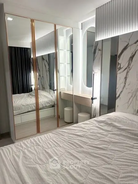 Luxurious bedroom with mirrored closet and elegant marble accents